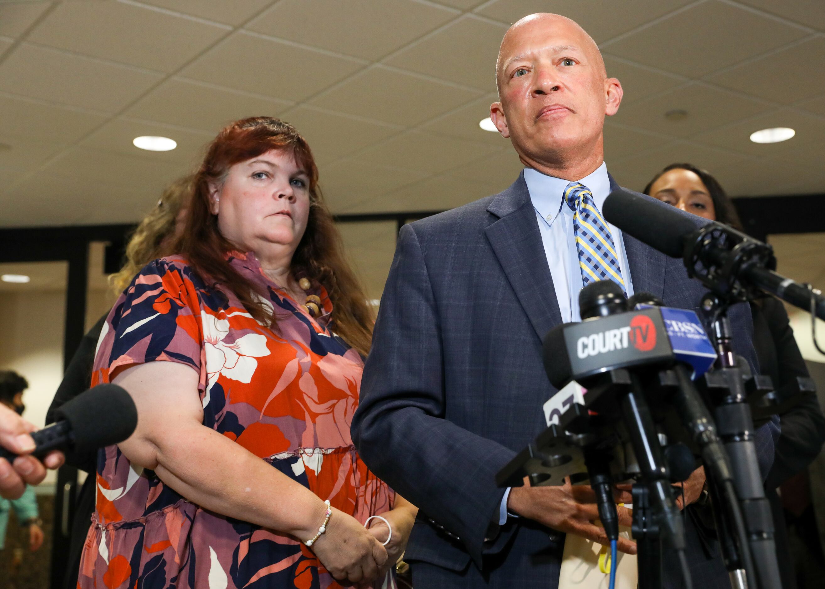 Patricia Owens (left) stands behind Dallas County district attorney John Creuzot after Yaser...