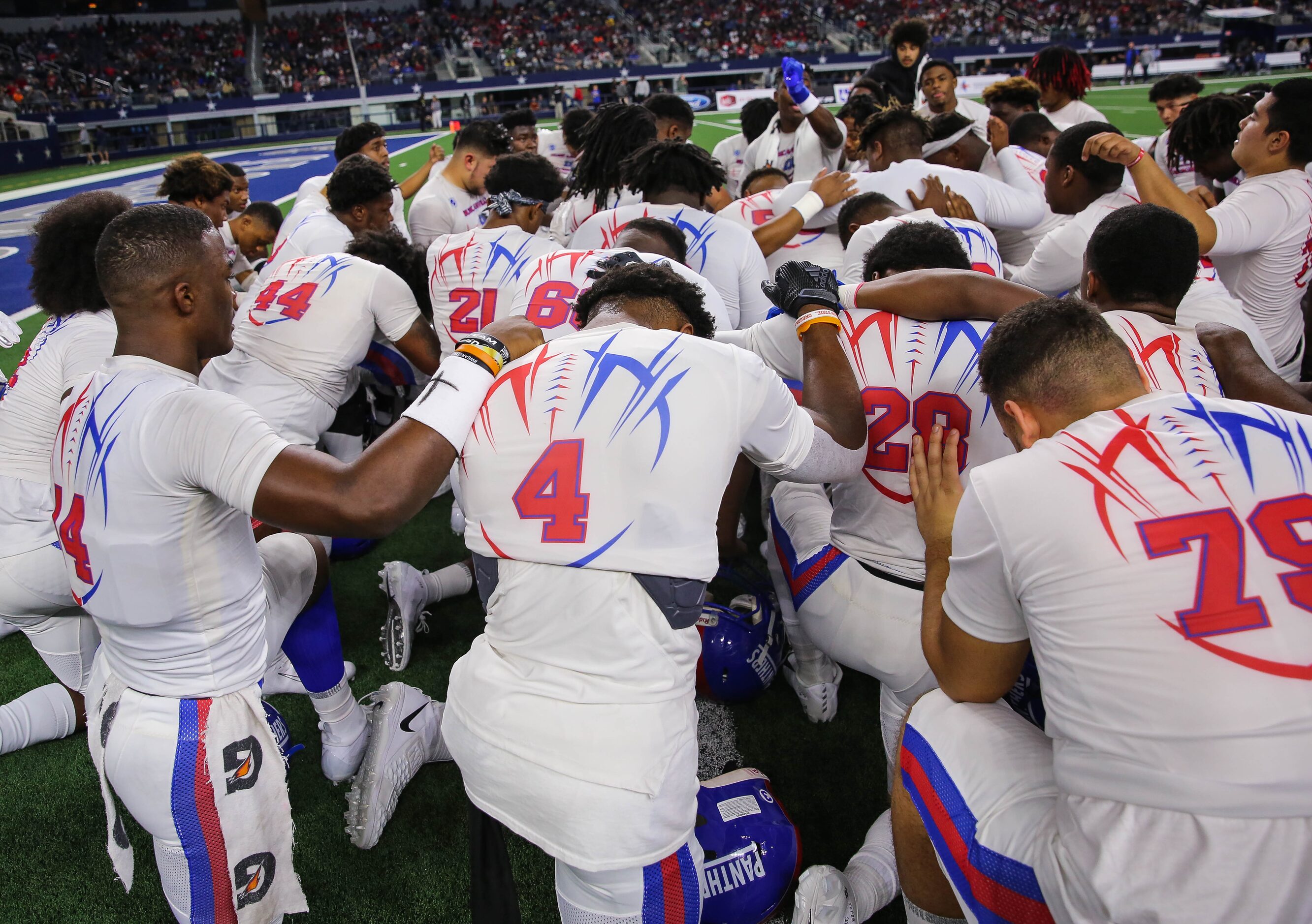 Duncanville players pray before a Class 6A Division I state championship game against Galena...