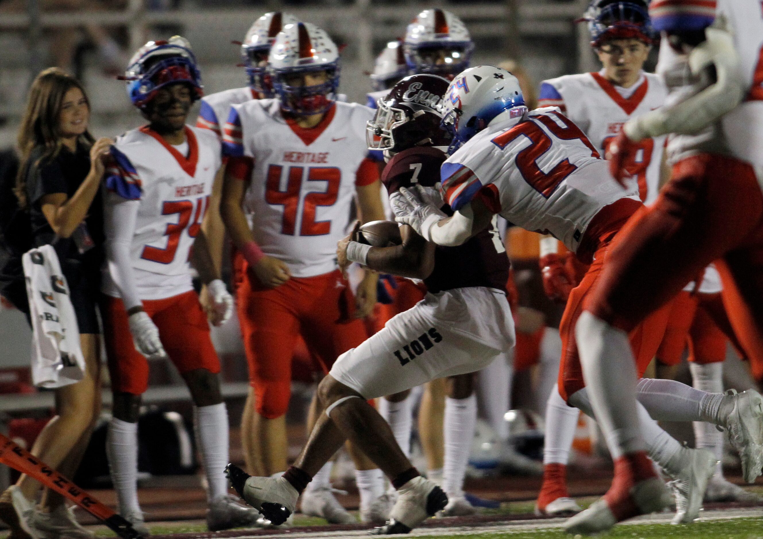 Ennis quarterback Wondame Davis Jr. (7) is forced out of bounds by Midlothian Heritage...