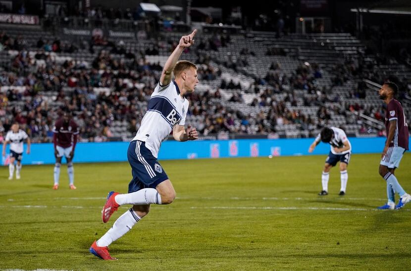 Vancouver Whitecaps midfielder Andy Rose (15) celebrates after scoring against the Colorado...