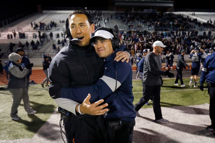 Frisco Lone Star head coach Jeff Rayburn (right) is congratulated by offensive coordinator...