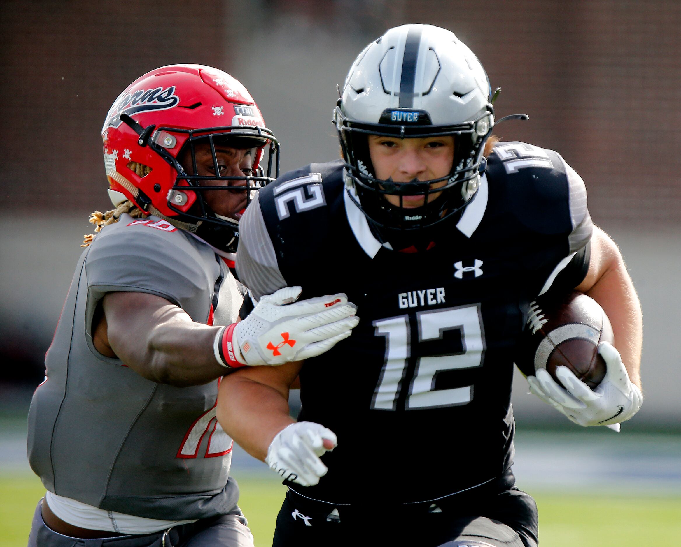 Denton Guyer High School wide receiver Nathan Wright (12) is caught by Cedar Hill High...