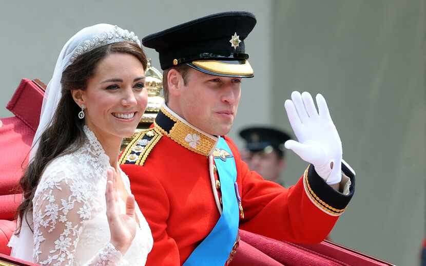 Britain's Prince William and his wife, Kate, waved as they traveled in a carriage along the...