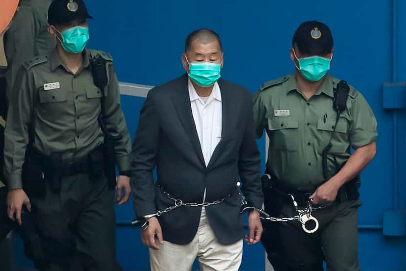 Jimmy Lai is escorted by Correctional Services officers to get on a prison van before...
