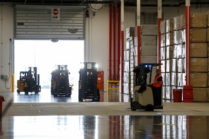 Workers stock a Home Depot distribution center on Tuesday in Dallas. (Ryan Michalesko/The...