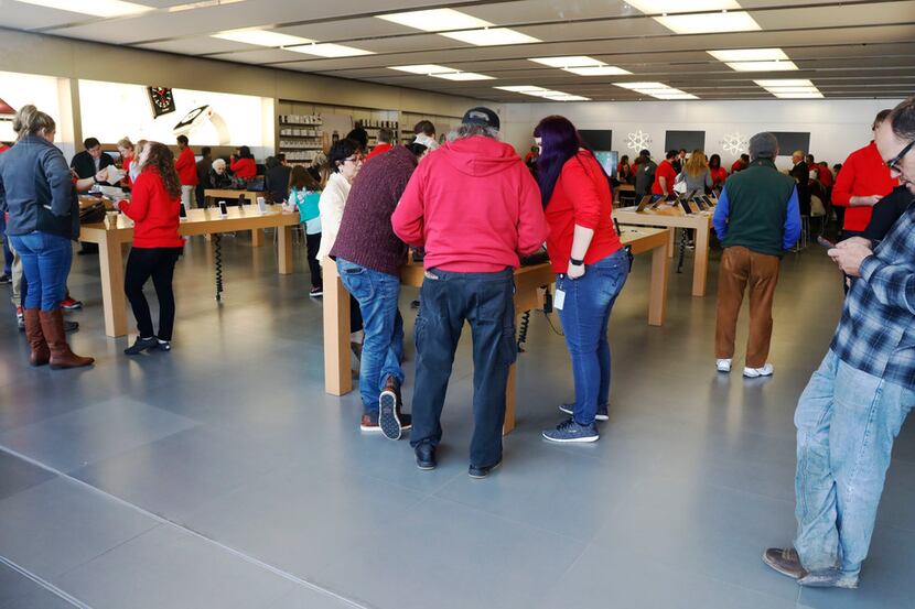 
Shoppers at the Apple store located at University Park Village, 1620 S University Dr, Fort...