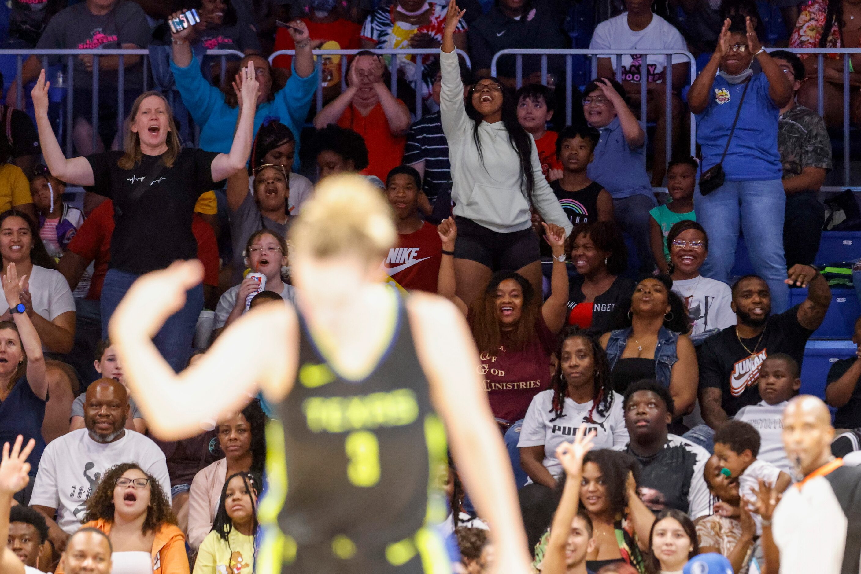 Crowd reacts as Dallas Wings guard Marina Mabrey (3) scores from a three-pointer against...