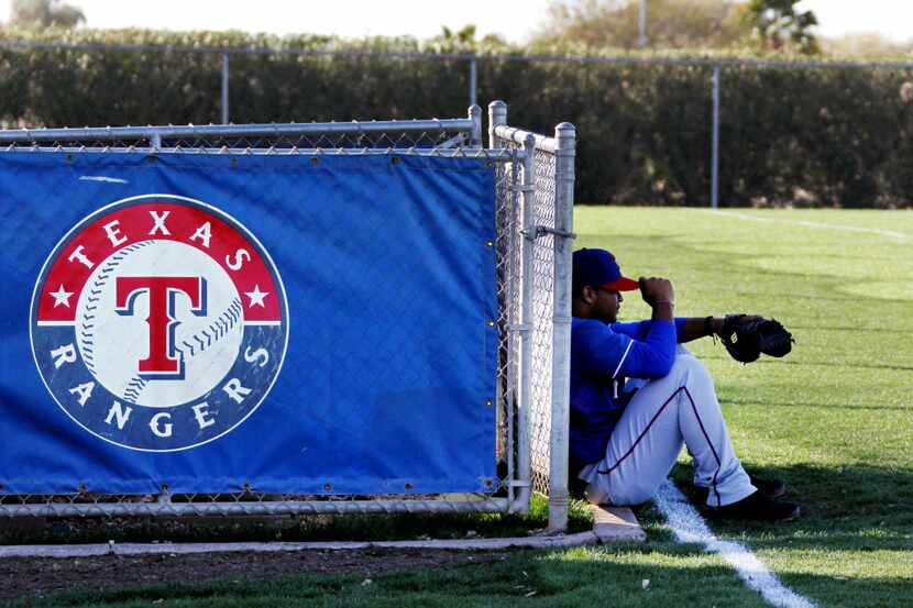 Texas Rangers' infielder Hanser Alberto waits for the rest of the team to take the field...