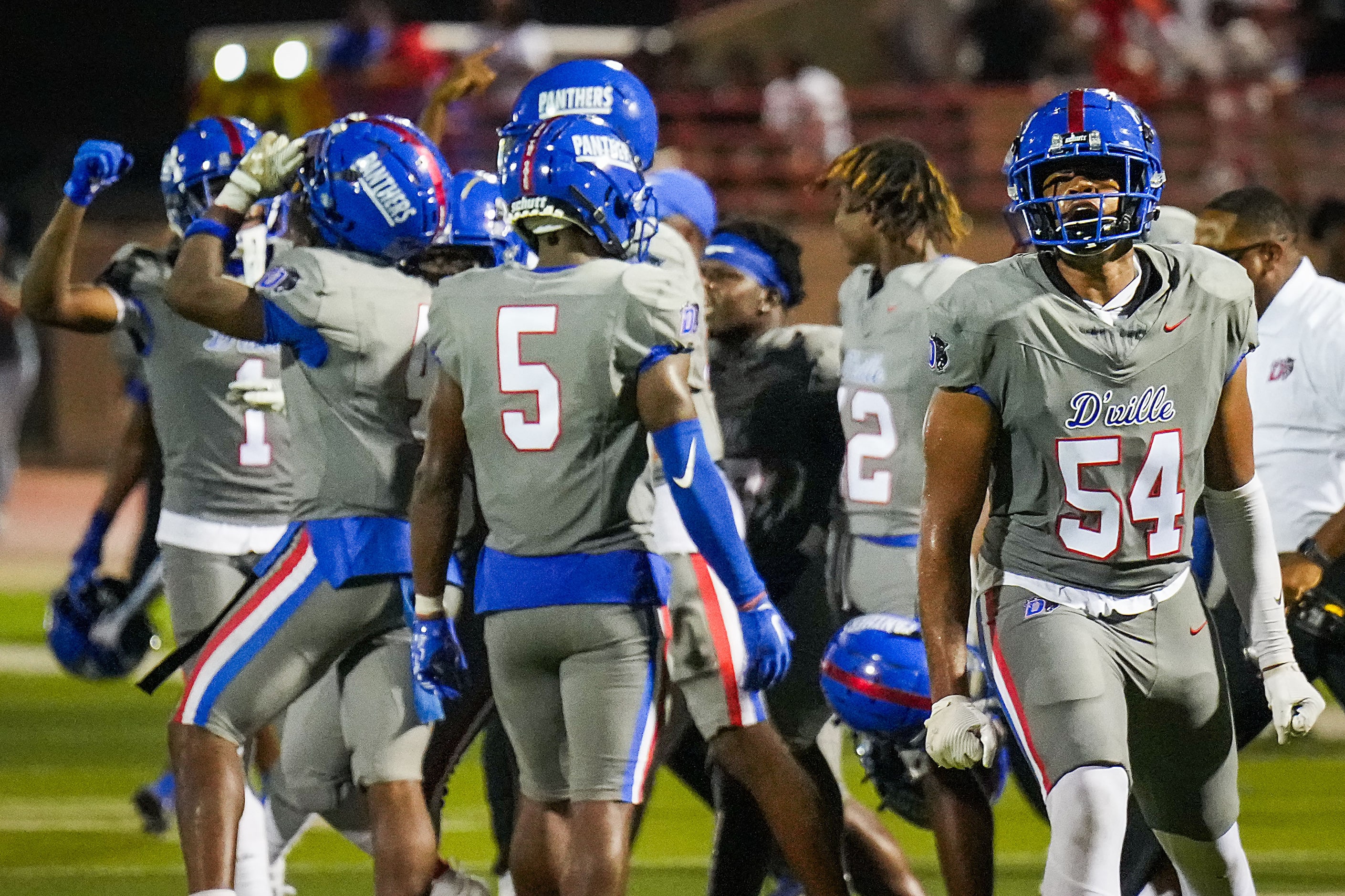 Duncanville offensive lineman Desean Bryant (54) celebrates with teammates as time expires...