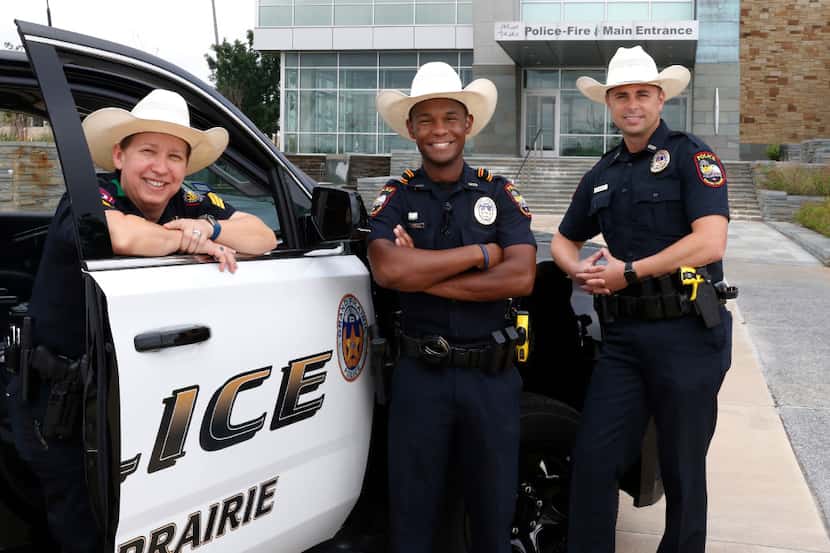 Grand Prairie police officers Sgt. Brandy Elliott (from left), Louis Johnson and Mark Beseda...