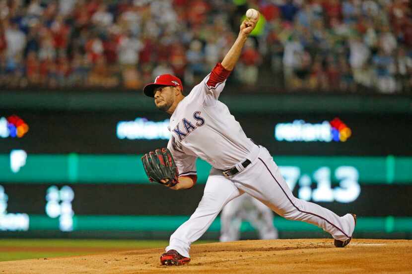 Texas Rangers starting pitcher Martin Perez (33) throws a first-inning pitch during Game 3...