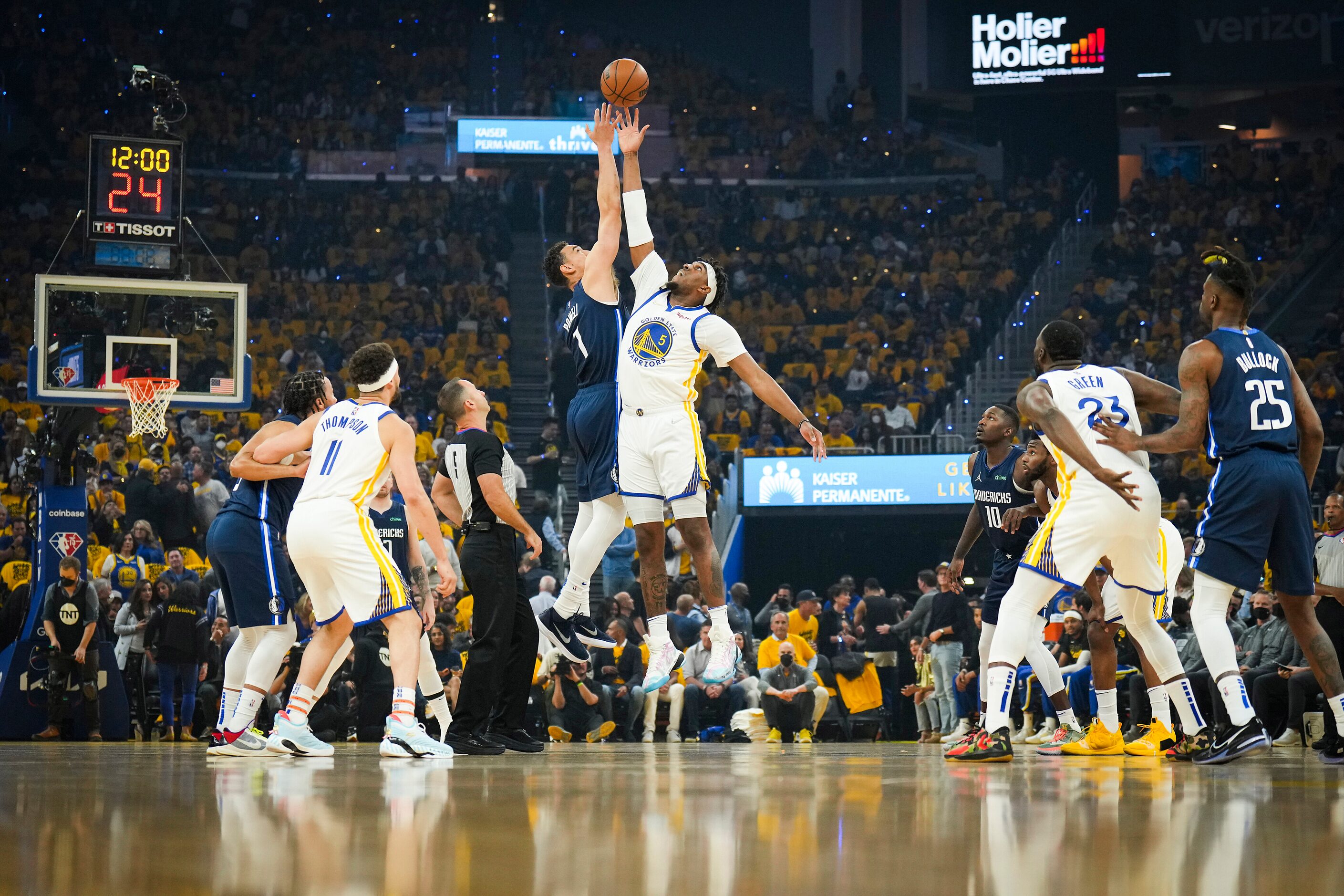 Dallas Mavericks center Dwight Powell (7) goes for the opening tipoff against Golden State...