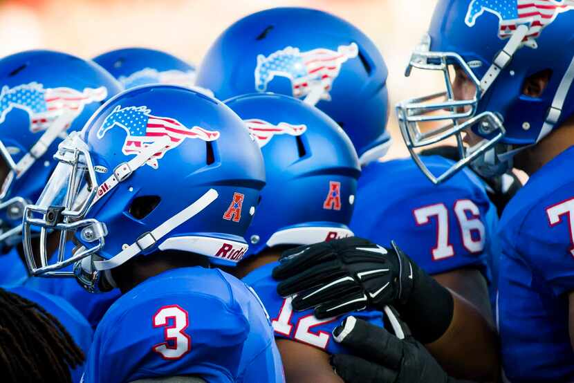 SMU players wearing special patriotic-themed helmets during an NCAA football game against...