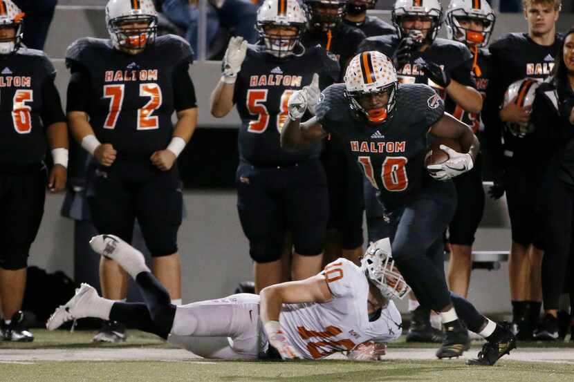 Haltom's Adam Hill runs after catching a pass against Arlington Bowie in the playoffs last...