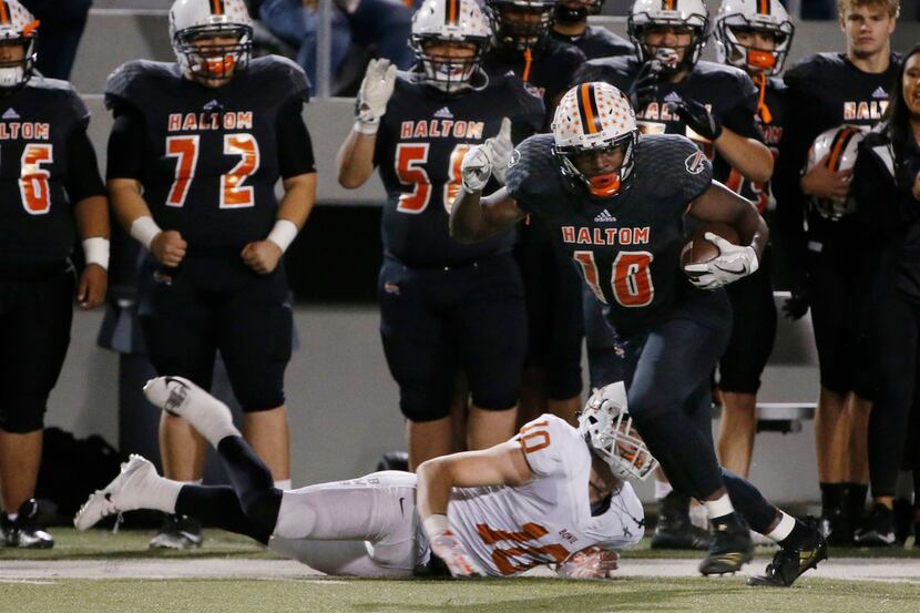 Haltom's Adam Hill runs after catching a pass against Arlington Bowie in the playoffs last...