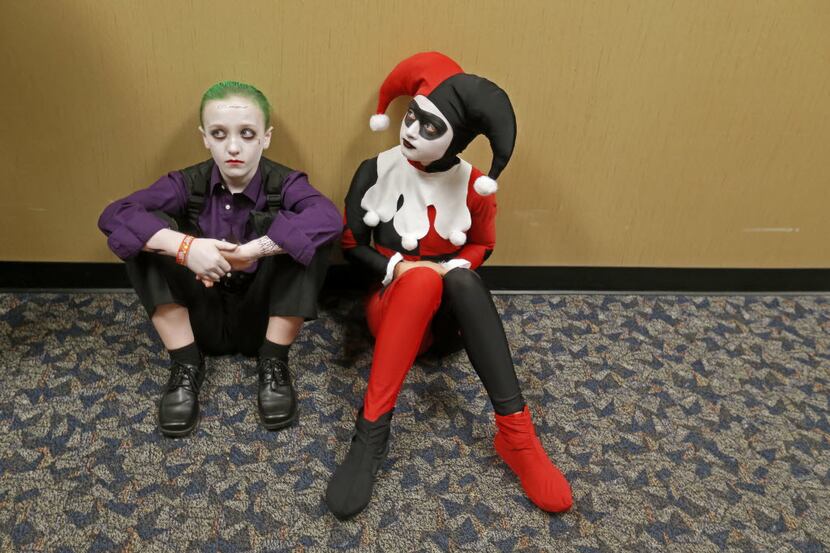 Cousins Peyton Brooks (left), 12, and Cassidy Miller, 14, sit in the hallway as they wait to...