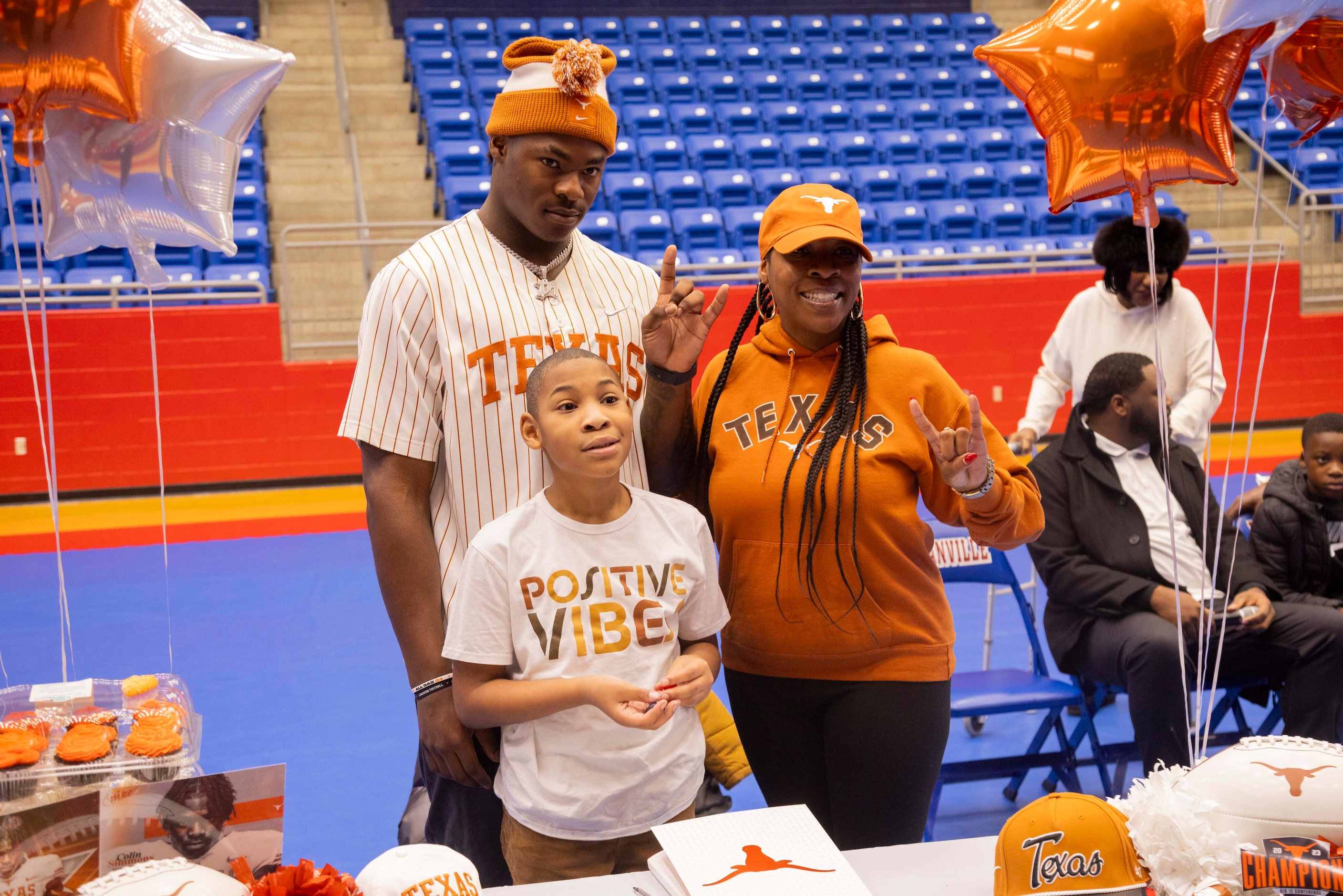 Defensive end Colin Simmons poses with his brother Clayton Roberts, 8, and mother Monica...