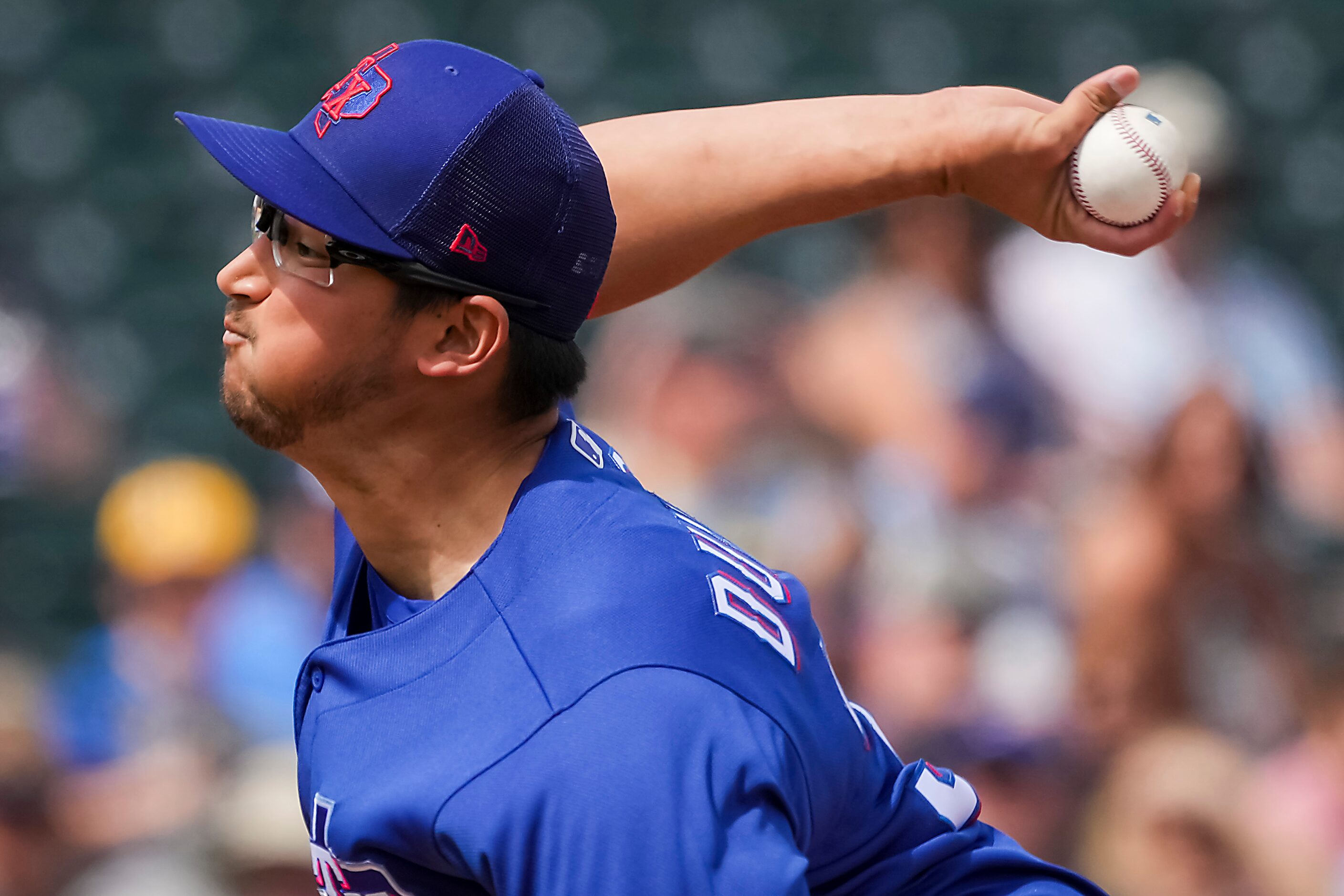 Texas Rangers pitcher Dane Dunning delivers during the first inning of a spring training...