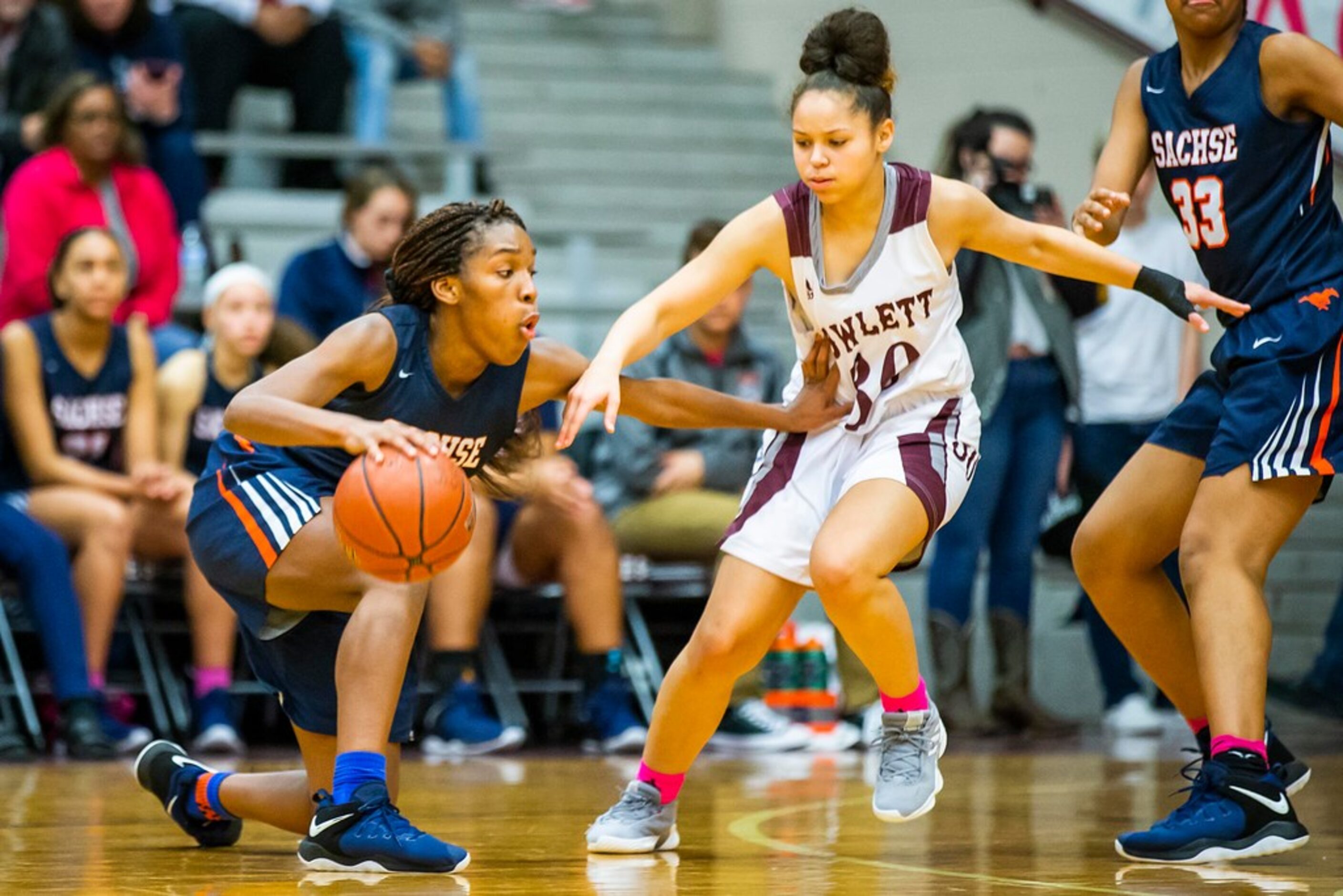 Sachse guard Tia Harvey tries to drive around Rowlett guard Mallorie Miller (30) during a...