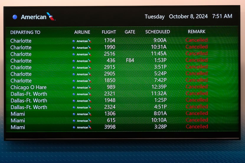 A message board at the Tampa International Airport shows all American Airlines departing...