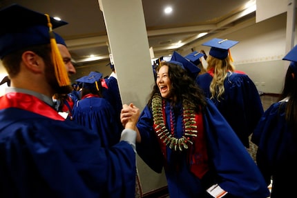 Wendy Birdsall is greeted by Lance Brooks, with whom she shared several classes, before...