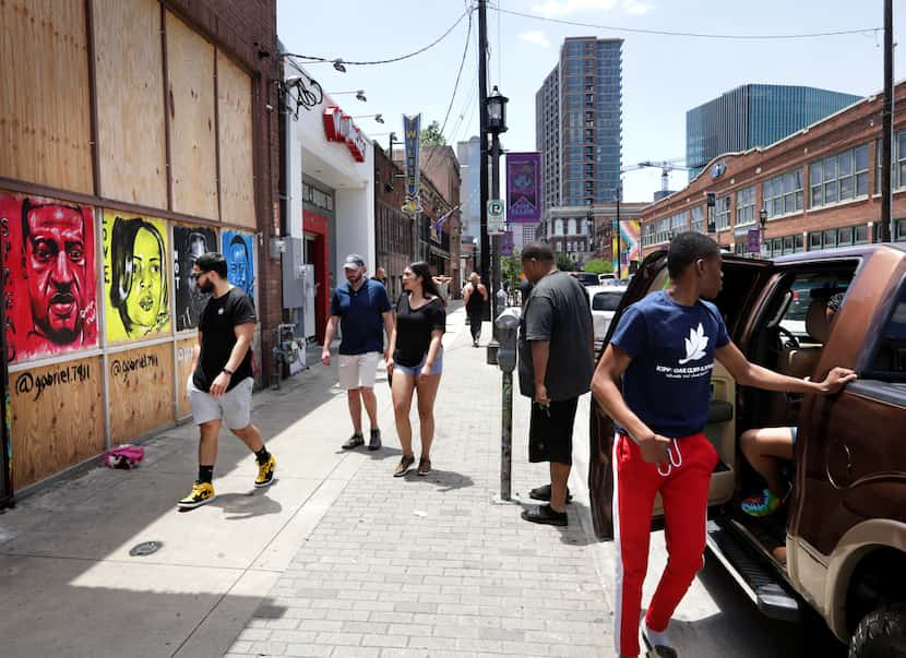 People view a mural by artist Gabriel Thomas at the former Glazed Donut Works space in Deep...