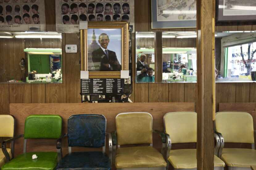 A portrait of President Barack Obama hangs in Nicholson’s Barber & Style Shop in Raleigh,...