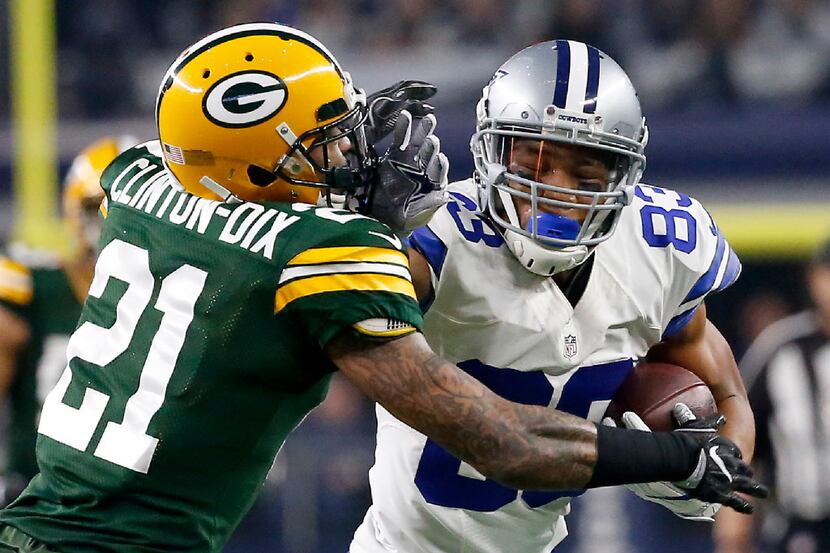 Dallas Cowboys wide receiver Terrance Williams (83) stiff arms Green Bay Packers free safety...