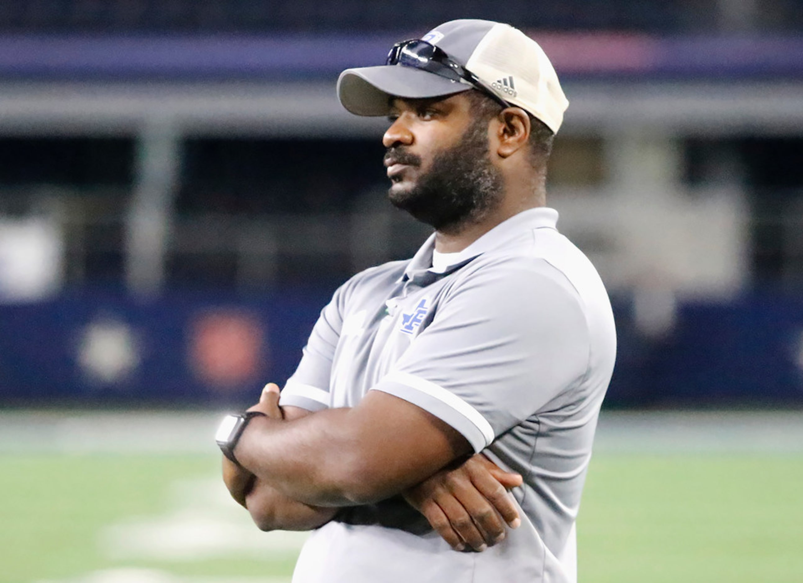 Omaha Pewitt High School head coach Triston Abron watches his team warm up before kickoff as...