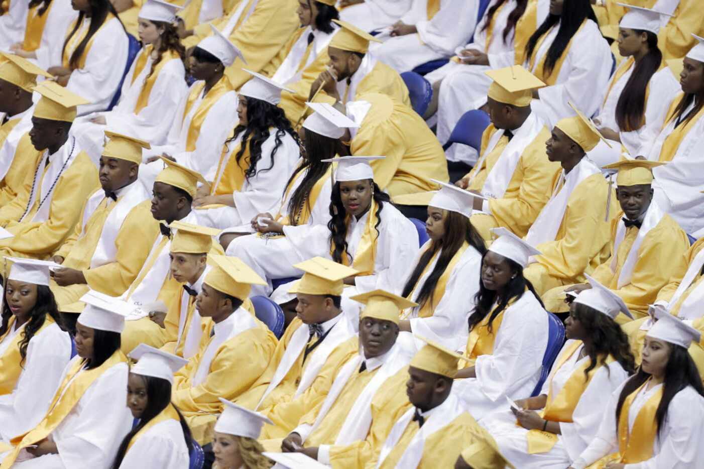 Members of the South Oak Cliff High School class of 2016 wait to receive their diplomas...