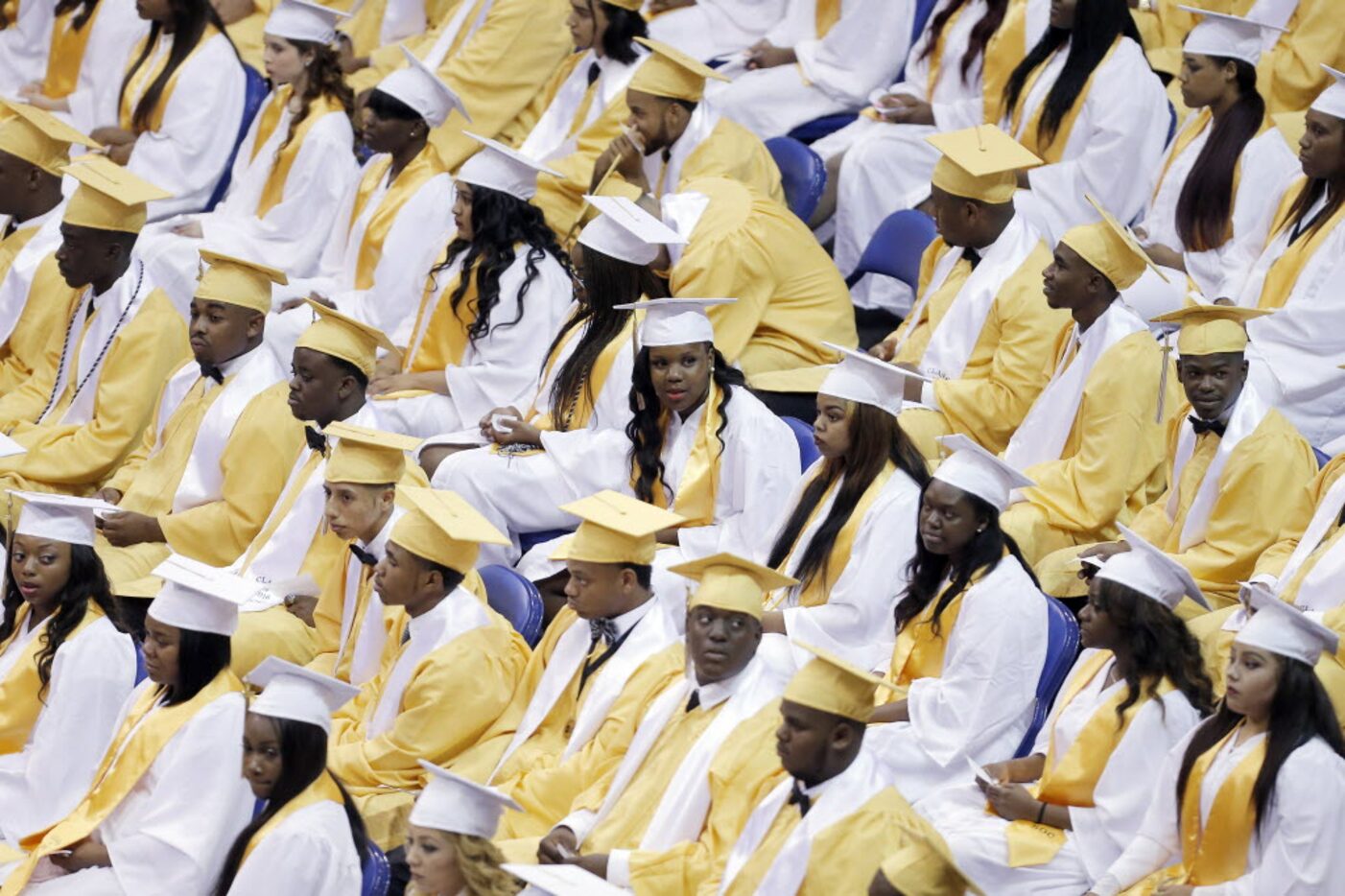 Members of the South Oak Cliff High School class of 2016 wait to receive their diplomas...