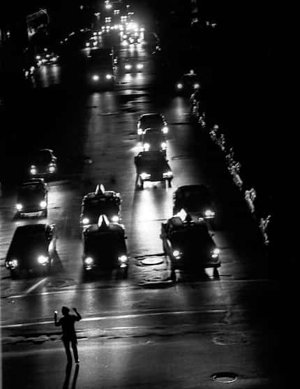 Cars provided the illumination on Third Avenue, at the corner of 58th Street, in Manhattan...