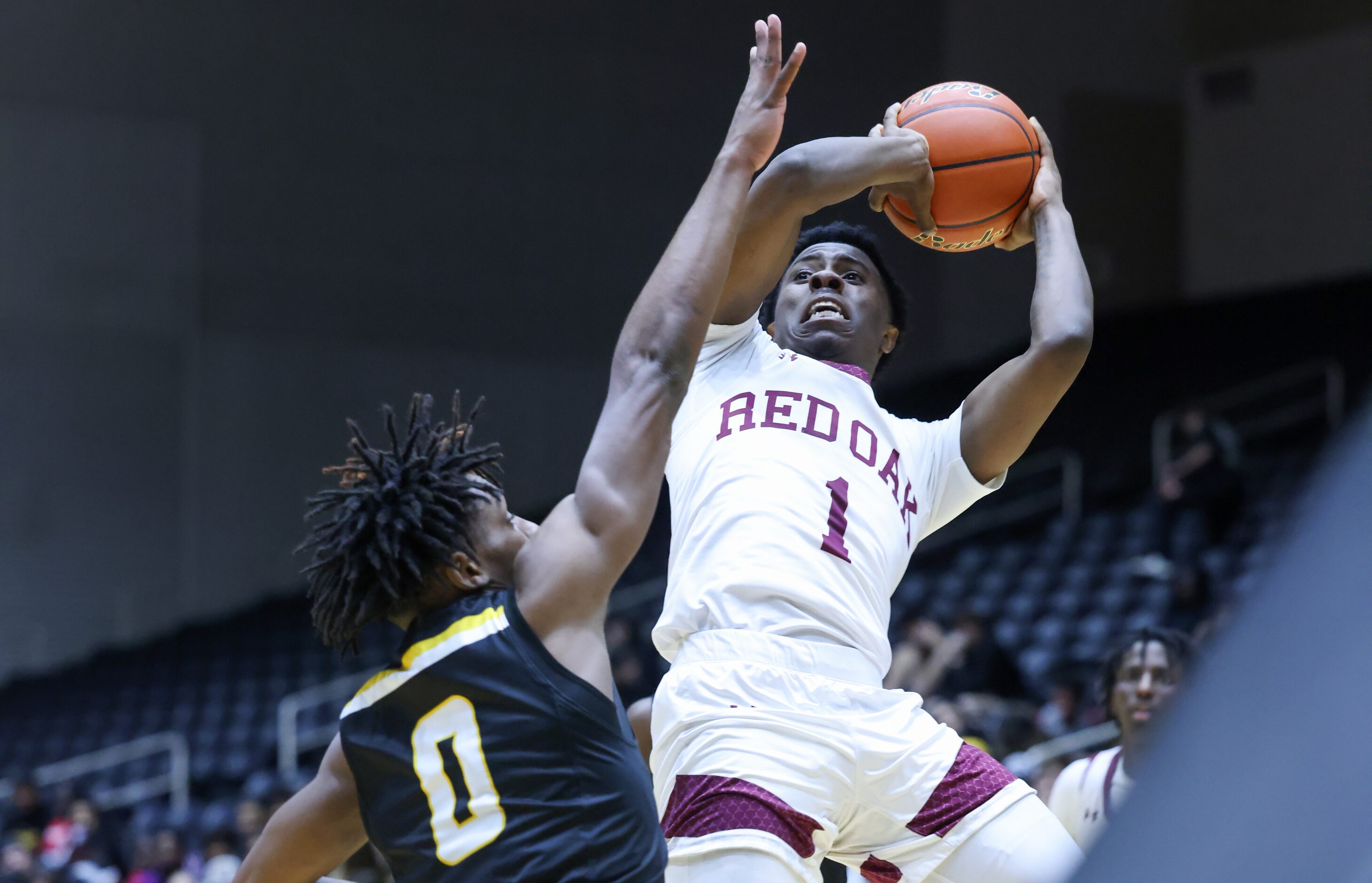 Forney senior forward Ronnie Harrison (0) reaches to block Red Oak senior guard Kirk...