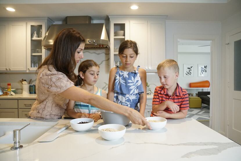 Kristen Massad preparing granola bars with her daughters Adele Massad (6) and Sophie Massad...