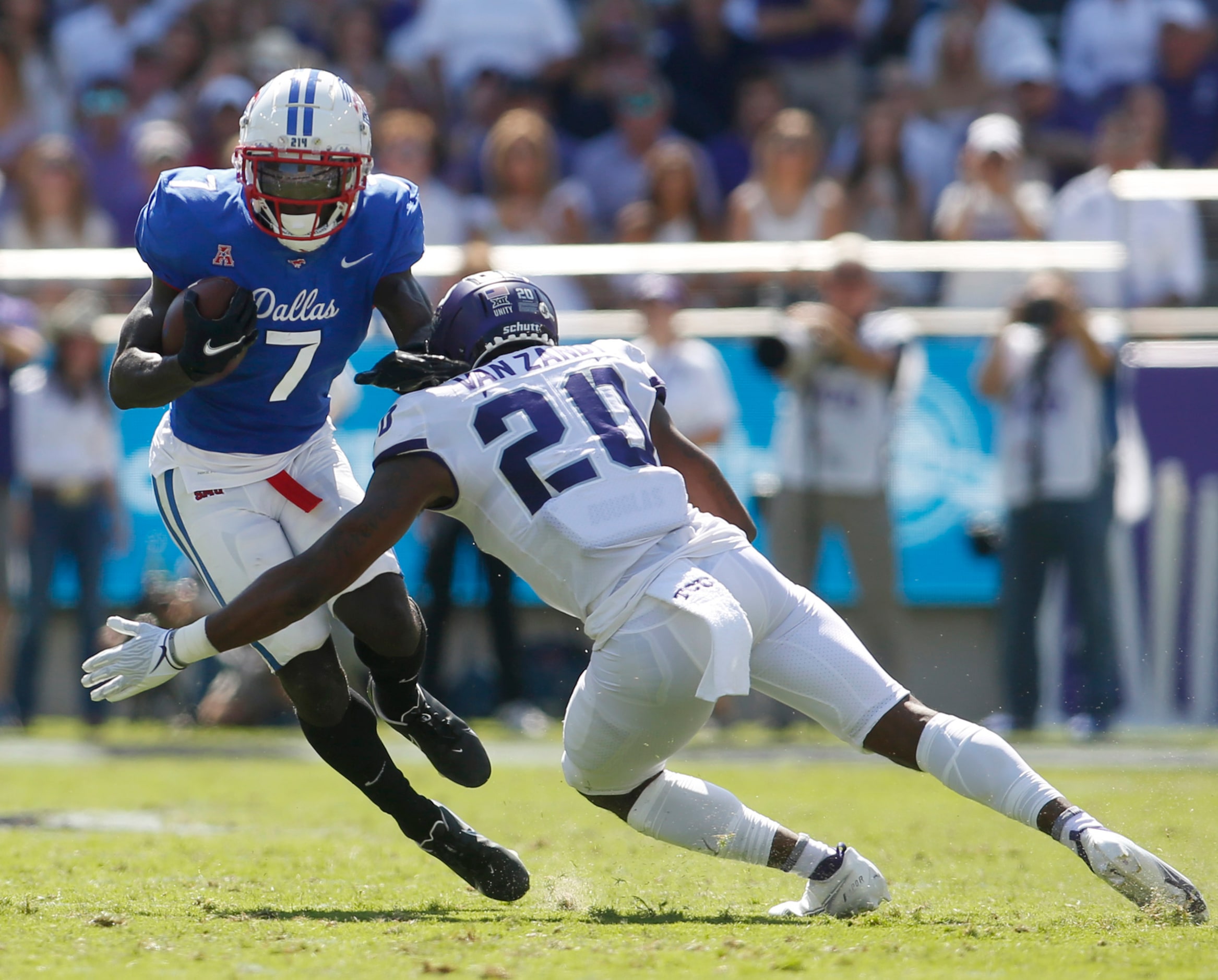 SMU running back Ulysses Bentley IV (7) tries to avoid the tackle of TCU safety LaKendrick...