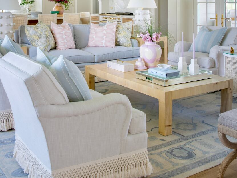 A living room features blue chairs with white fringe trim.