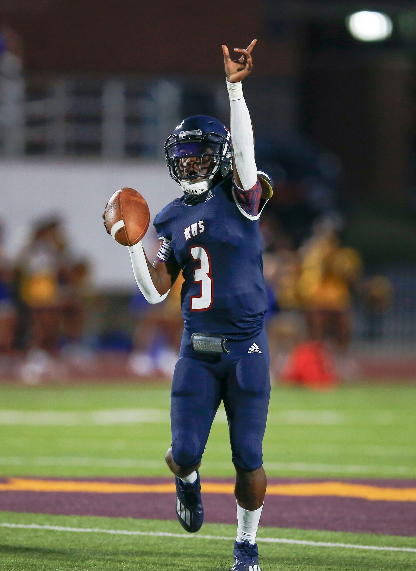 Kimball senior quarterback Jerqualan Parks signals to a receiver during the first half of a...