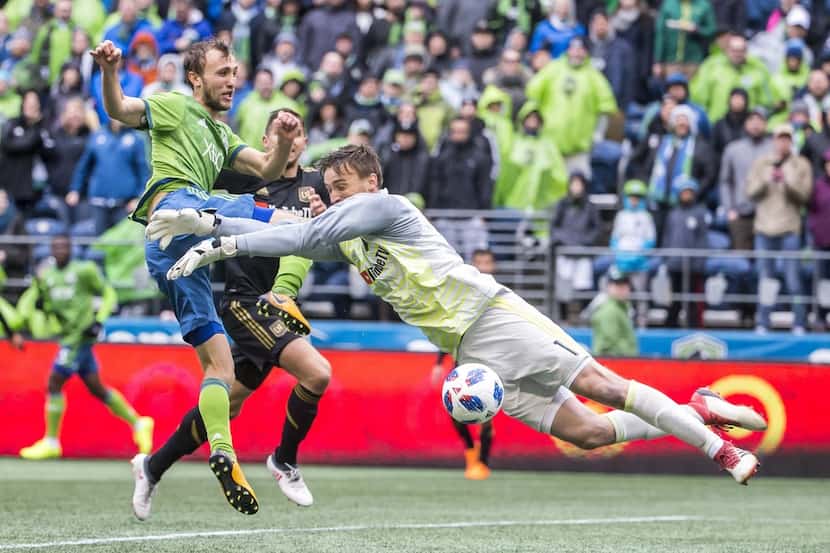 Seattle Sounders midfielder Magnus Wolf Eikrem takes a shot, saved by Los Angeles FC...