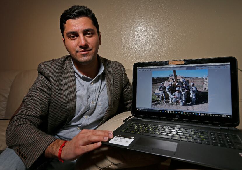 Ibrahim Yousif shows a laptop photo of him with American soldiers at his apartment in Plano,...