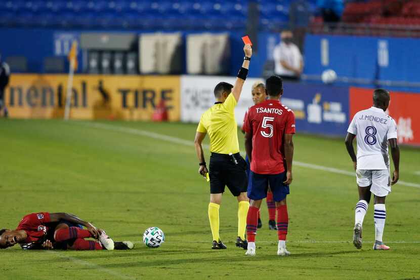 Orlando City midfielder Sebas Mendez (8) gets a red card as FC Dallas forward Bryan Reynolds...