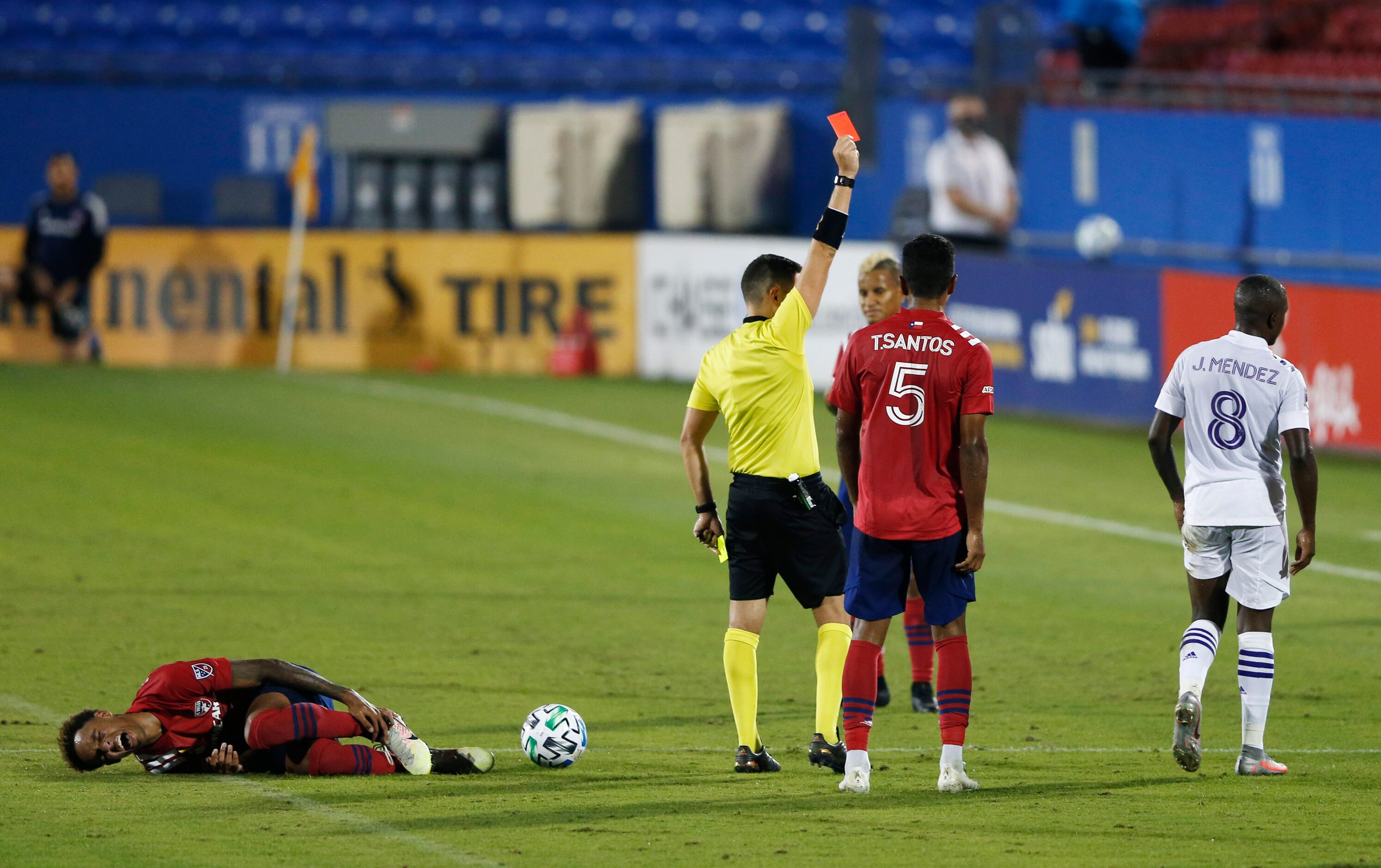 Orlando City midfielder Sebas Mendez (8) gets a red card as FC Dallas forward Bryan Reynolds...