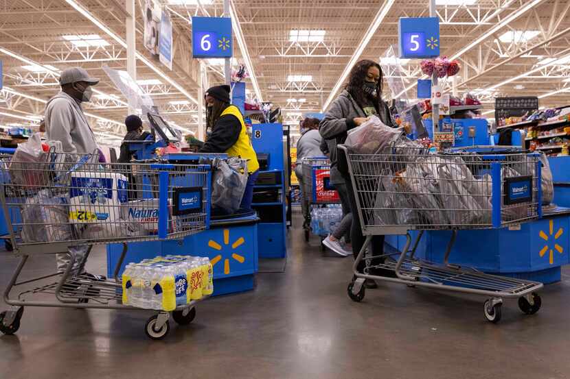 Shoppers went through checkout at the Walmart in South Dallas at 200 Short Blvd. on Tuesday...