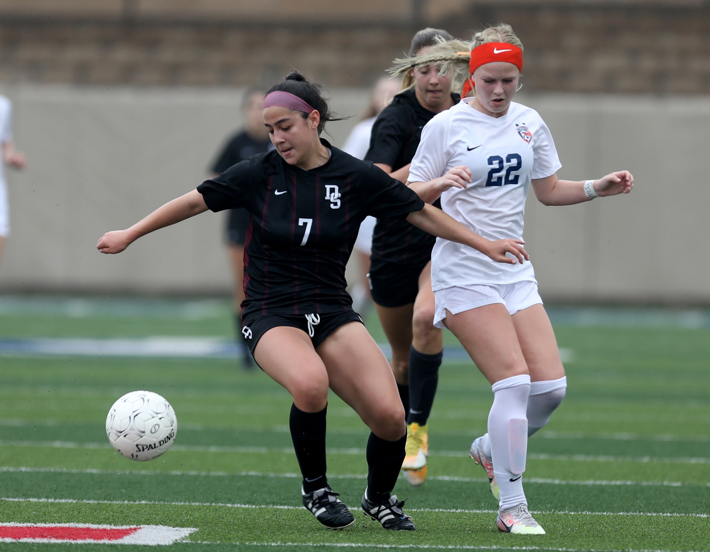 Dripping Springs' Rylie Flores  (7)  and Wakeland's McKenna Jenkins (22) chase after the...