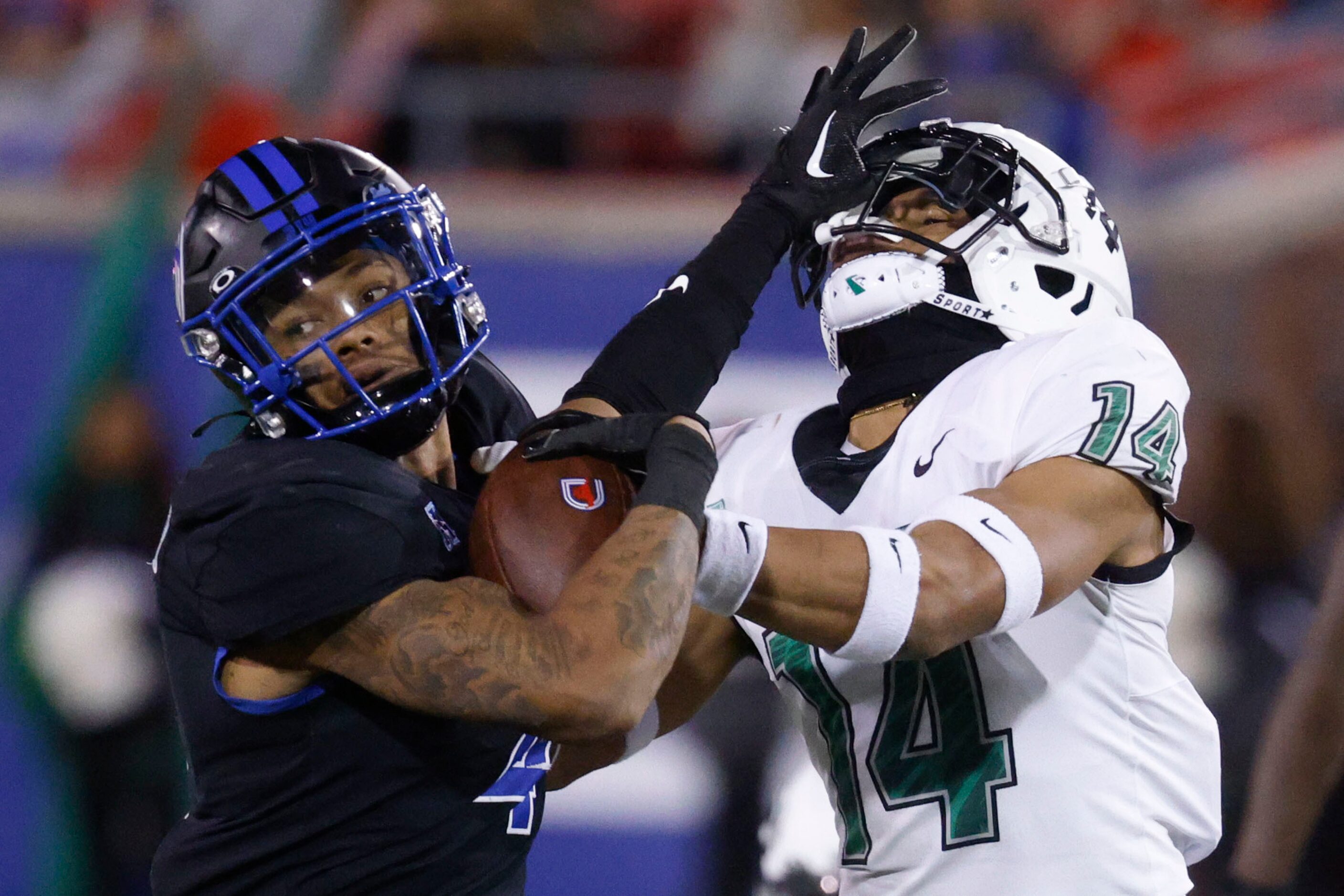 Southern Methodist Mustangs running back Jaylan Knighton (left) blocks North Texas Mean...