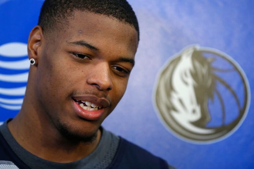 Dallas Mavericks first round pick Dennis Smith Jr. talks with the media after practice at...