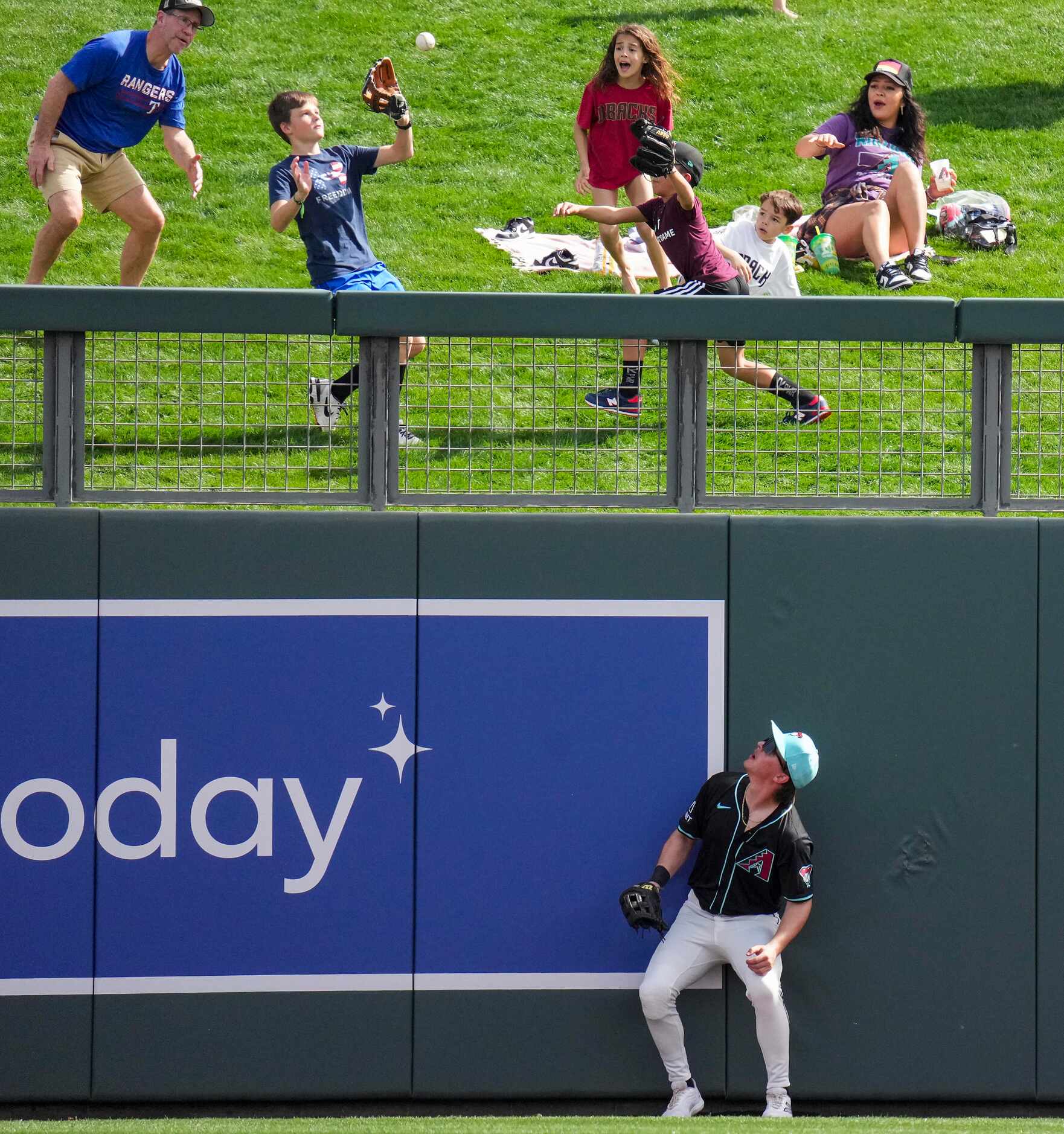 Arizona Diamondbacks right fielder Jake McCarthy watches as fans chase a 2-run home run ball...