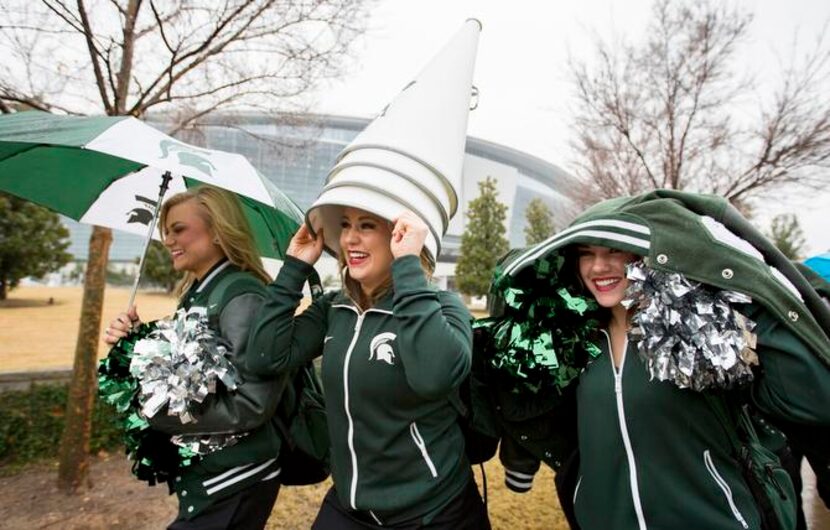 
A stack of megaphones served as a rain hat for Effie Oates as she and other Michigan State...