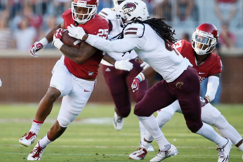 Louisiana Monroe safety Tre' Hunter, front right, moves in to tackle Oklahoma running back...