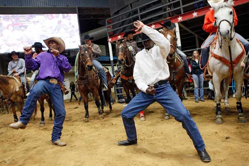 Cowboys Dennis Ezell, also known as Bronco, left, and Tyrone Williams show off their dancing...