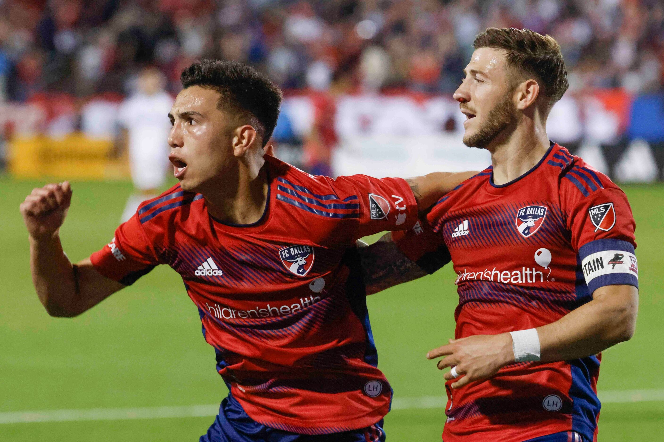 FC Dallas forward Alan Velasco (left) and forward Paul Arriola celebrates a goal during the...